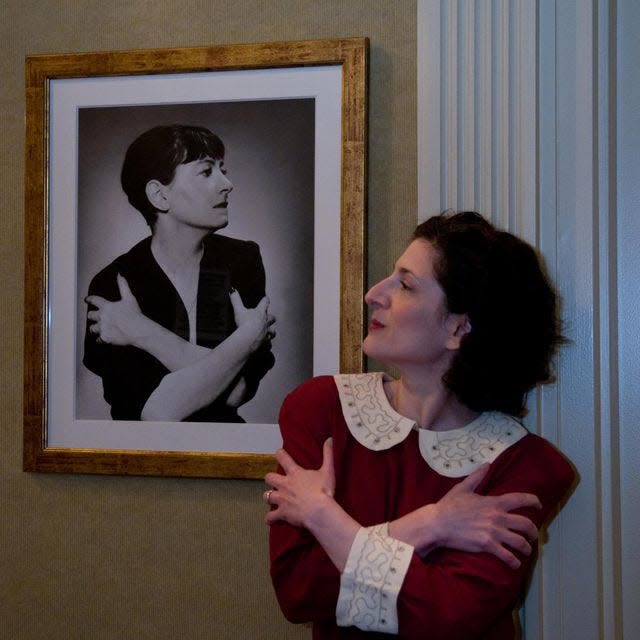 Actress Carol Lempert, right, faces off with a photo of the acerbic wit she played in "That Dorothy Parker."