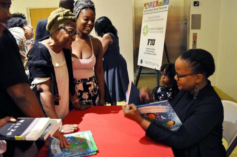 Haitian author Edwidge Danticat will read from her latest work, “My Mommy Medicine,” at noon Sunday at the festival. Here, she is signing her children’s book, “Mama’s Nightingale,” at last year’s festival.