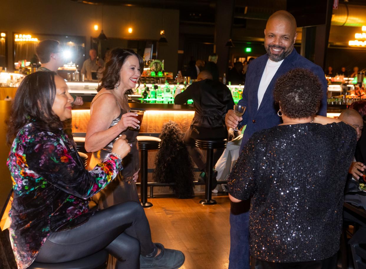 Nearest Green co-founder Keith Weaver, top right, speaks with guests at the distillery’s restaurant and bar, Humble Baron, during a holiday party Friday, Dec. 8, 2023.