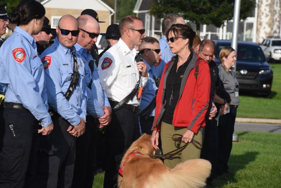 Deborah Forster and therapy dog Ferris greet first responders at the 9/11 memorial on Sept. 11, 2023.