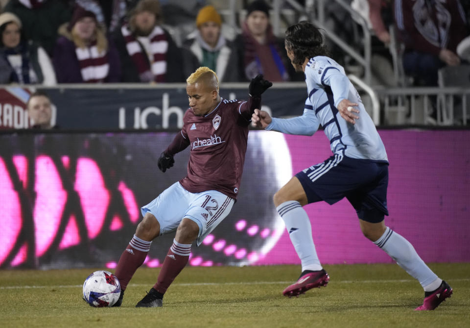 Colorado Rapids forward Michael Barrios, left, kicks the ball as Sporting Kansas City defender Ben Sweat defends during the first half of an MLS soccer match Saturday, March 4, 2023, in Commerce City, Colo. (AP Photo/David Zalubowski)