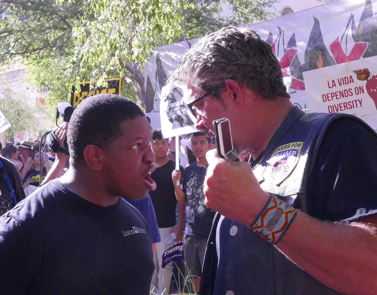 Jarvis Johnson and Bikers for Trump founder Chris Cox argue outside of President Trump’s rally in Phoenix, Aug. 22, 2017. (Photo: Hunter Walker/Yahoo News)