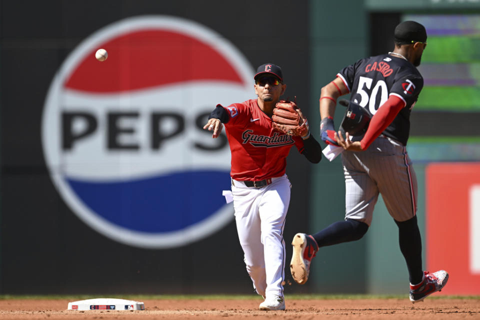 Cleveland Guardians’ Andrés Giménez, left, throws out Minnesota Twins’ Manuel Margot at first base after forcing out Willi Castro (50) at second base to complete a double play during the third inning of a baseball game, Thursday, Sept. 19, 2024, in Cleveland. (AP Photo/Nick Cammett)