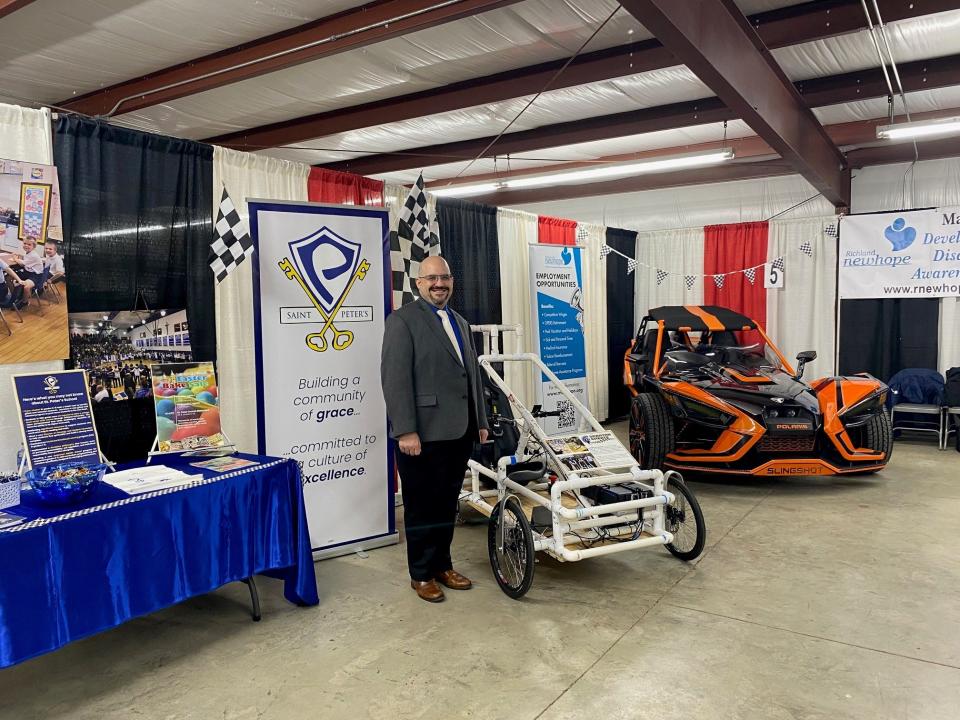 Jason Crundwell of St. Peter's School shows off the high school student team's go kart on display at the 2023 Chamber Business Expo. The electric go kart will be part of a race by college and high school students at Mid-Ohio Sports Car Course on May 2.