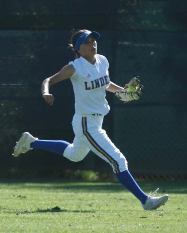 Linden's Millee Holguin catches a ball in the outfield during one of the Lions softball games during the 2023-24 season.