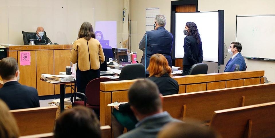 Former Cohasset teacher Jeffrey Knight, right, listens as his sex assault trial begins in Quincy District Court on Monday, Nov. 15, 2021.