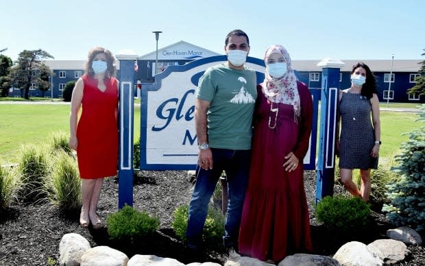 CEO Lisa M. Smith, left, Khodor and Maya Ramlawi, centre, and employee relations specialist Janice Jorden are shown in front of Glen Haven Manor in New Glasgow, N.S. The couple were living outside of a Palestinian refugee camp in Lebanon with their two daughters before arriving in Nova Scotia. (Shaina Luck/CBC - image credit)