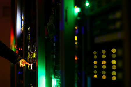 FILE PHOTO: A man poses inside a server room at an IT company in this June 19, 2017 illustration photo. REUTERS/Athit Perawongmetha/Illustration/File Photo