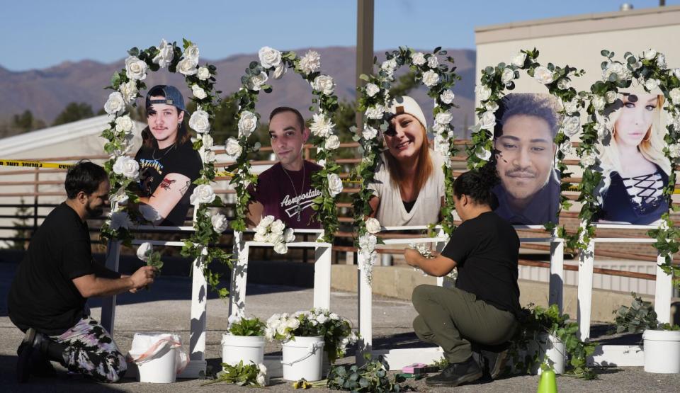 A memorial with flowers and photos of people