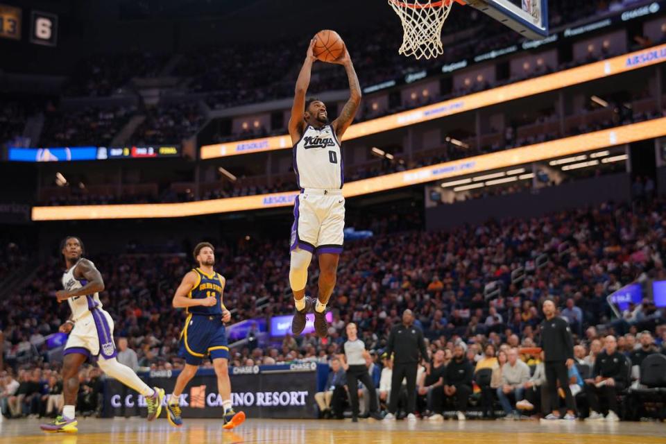 Sacramento Kings guard Malik Monk (0) dunks the ball in front of Golden State Warriors guard Klay Thompson (11) in the second quarter Wednesday, Nov. 1, 2023, at the Chase Center in San Francisco.