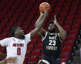 Wake Forest's Isaiah Wilkins (23) shoots as North Carolina State's D.J. Funderburk (0) defends during the first half of an NCAA college basketball game Wednesday, Jan. 27, 2021, in Raleigh, N.C. (Ethan Hyman/The News & Observer via AP, Pool)