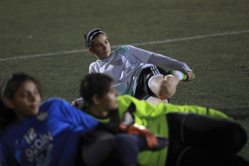 Masar Athamneh stretches during a training of the Orthodox Club's women's team in Amman, Jordan, Saturday, Oct. 22, 2022. Women's soccer has been long been neglected in the Middle East, a region that is mad for the men's game and hosts the World Cup for the first time this month in Qatar. (AP Photo/Raad AL-Adayleh)