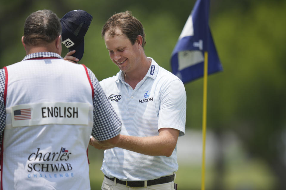 Harris English, right, takes off his cap after finishing the 18th hole during the second round of the Charles Schwab Challenge golf tournament at Colonial Country Club in Fort Worth, Texas, Friday, May 26, 2023. (AP Photo/LM Otero)