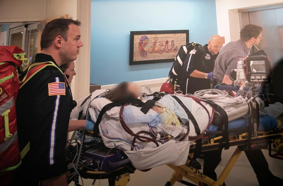 A teenager whose vaping caused irreparable damaged to his lungs is shown (with a blurred face) as he is being transferred to Henry Ford Hospital in Detroit. A medical team used a portable ECMO machine to keep the patient alive during the transfer from Children's Hospital of Michigan.