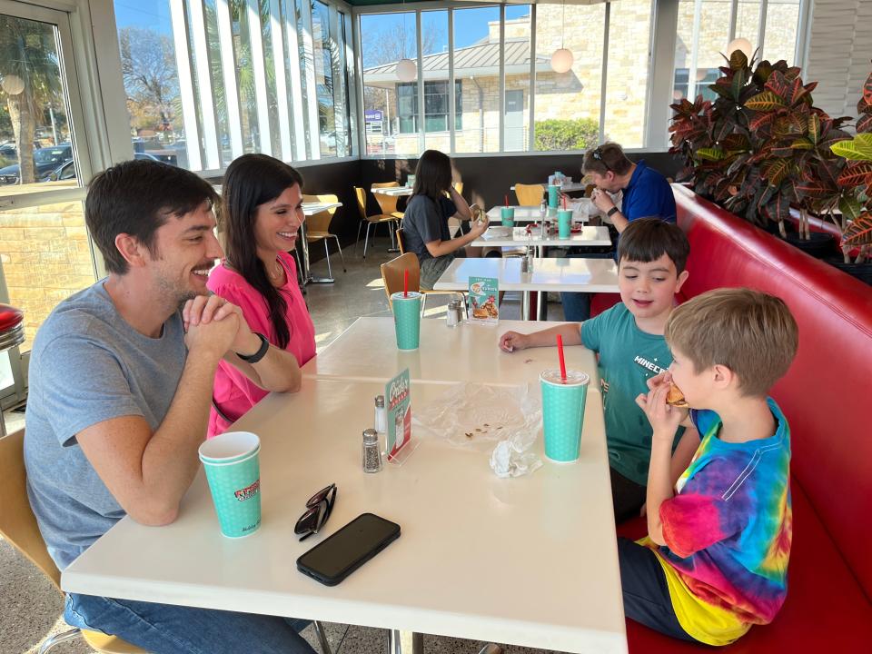 Rosie and Joseph Pierce and their sons, Remy, 5, and Benson, 8, finish up their P. Terry's lunch Saturday. P. Terry's profits for the day went to Season for Caring.