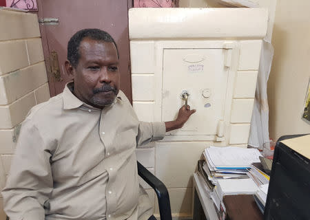 Lawyer Mohamed Mahmoud holds the lock of his safe box behind his desk in Khartoum, Sudan September 6, 2018. REUTERS/Eric Knecht