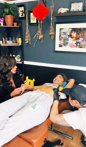 <p>Milania Giudice/TikTok</p> Teresa Giudice sits with Milania as she gets first tattoo