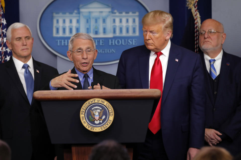 FILE - In this Saturday, Feb. 29, 2020 file photo, National Institute for Allergy and Infectious Diseases Director Dr. Anthony Fauci speaks as President Donald Trump and Vice President Mike Pence listen during a briefing about the coronavirus in the press briefing room at the White House in Washington. At right is Robert Redfield, director of the Centers for Disease Control and Prevention. Fauci has said he isn't active in organized religion but credited his Jesuit schooling with burnishing the values that drive his public service. (AP Photo/Carolyn Kaster)