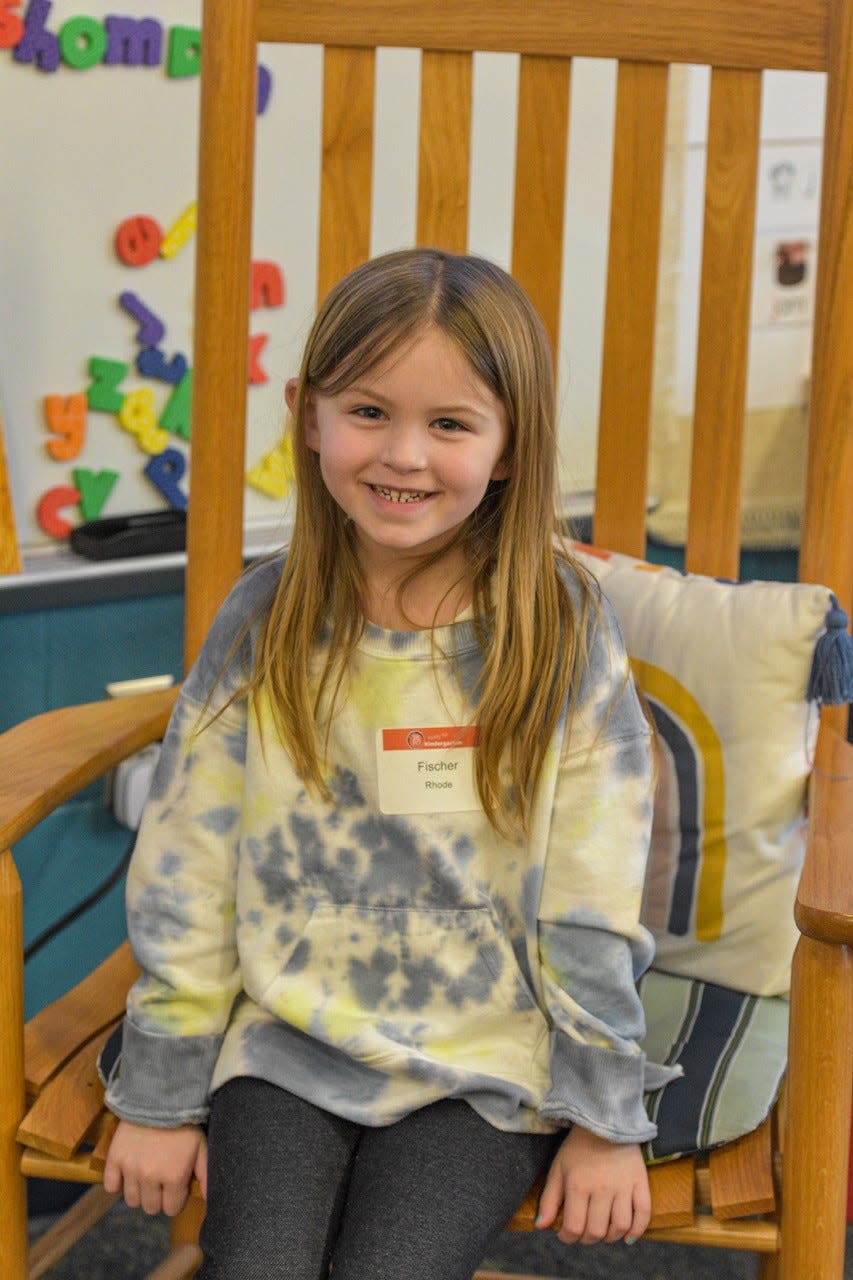 Fischer Rode takes a break from playing to sit in Ashley Carmon’s big rocking chair during Kindergarten Kickoff. Rode said she didn’t know what she would learn next year in kindergarten, but she was excited to start.