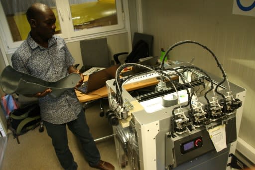 Technician Fabrice Agbelehounko Djodji checks the work of a 3D printer used to produce prosthetic supports at the African Organisation for the Development of Centres for Disabled People in Lome. Making 3D devices locally is expected to cut costs