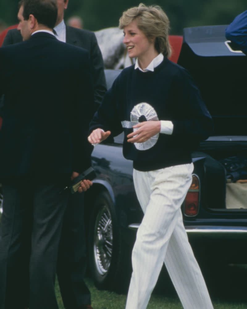 <p> Pictured here at Smith Lawns in Windsor for the Guards Polo Club match, her outfit consisted of white straight-leg trousers, a logo crewneck jumper with a crisp white shirt poking through the collar and sleeves. Once again, Diana shows off her cool and effortlessly chic style at the polo. </p>