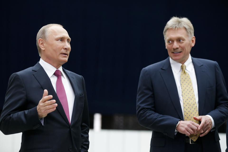 FILE - In this Thursday, June 15, 2017 file photo Russian President Vladimir Putin speaks to the media after his annual televised call-in show as his press secretary Dmitry Peskov, right, smiles in Moscow, Russia. Russian President Vladimir Putin's spokesman Peskov said Tuesday May 12, 2020, that he is hospitalized with the coronavirus. The announcement comes just a day after Putin said Russia was successful in slowing down infections and announced easing some of the nationwide lockdown restrictions. (AP Photo/Alexander Zemlianichenko, File)