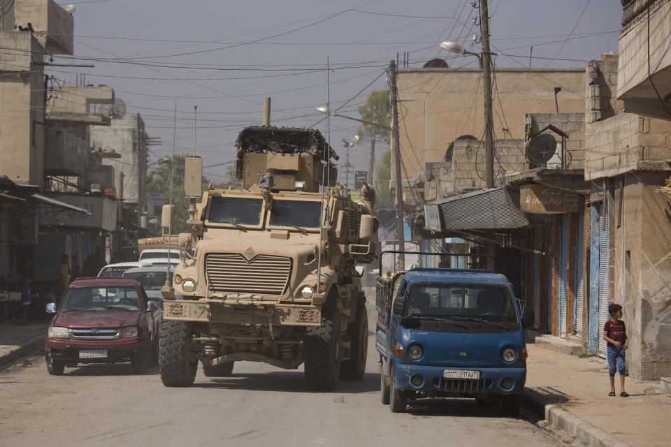 A U.S. armored vehicle drives through Tal Abyad, Syria, on a joint patrol with the Tax Abyad Military Council, an affiliate of the U.S.-backed Syrian Democratic Forces Friday, Sept. 6, 2019. Once part of the sprawling territories controlled by the Islamic State group, the villages are under threat of an attack from Turkey which considers their liberators, the U.S-backed Syrian Kurdish-led forces, terrorists.T o forestall violence between its two allies along the border it has helped clear of IS militants, Washington has upped its involvement in this part of Syria.. (AP Photo/Maya Alleruzzo)