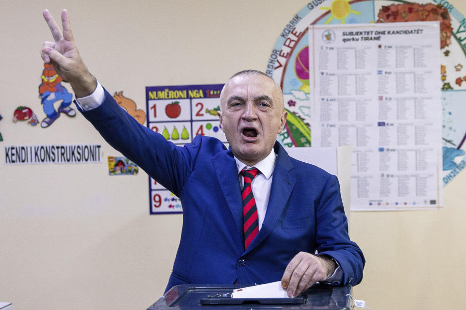 Albanian president Ilir Meta flashes victory sign as he casts his vote during parliamentary elections in capital Tirana, Albania on Sunday, April 25, 2021. Albanian voters have started casting ballots in parliamentary elections on Sunday amid the virus pandemic and a bitter political rivalry between the country's two largest political parties. (AP Photo/Visar Kryeziu)