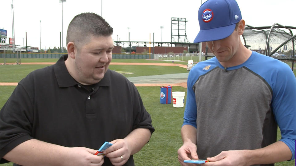 Kyle Hendricks opening old Topps cards from 1992. (Yahoo Sports)