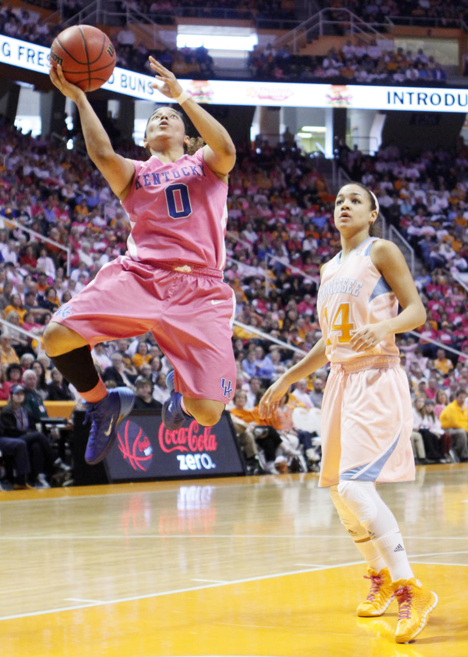 Kentucky guard Jennifer O'Neill (0) shoots past Tennessee guard Andraya Carter (14) in the second half of an NCAA college basketball game on Sunday, Feb. 16, 2014, in Knoxville, Tenn. Kentucky won 75-71. (AP Photo/Wade Payne)