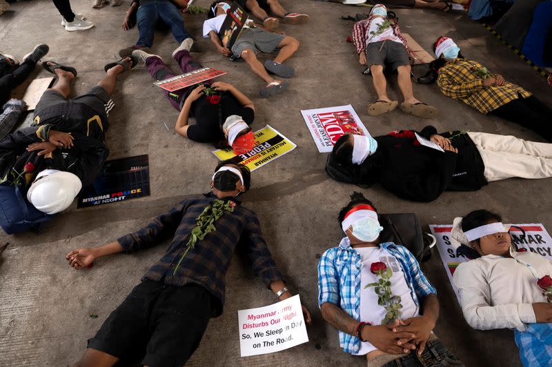 People lie down on the floor as they take part in a protest against the military coup in Yangon, Myanmar