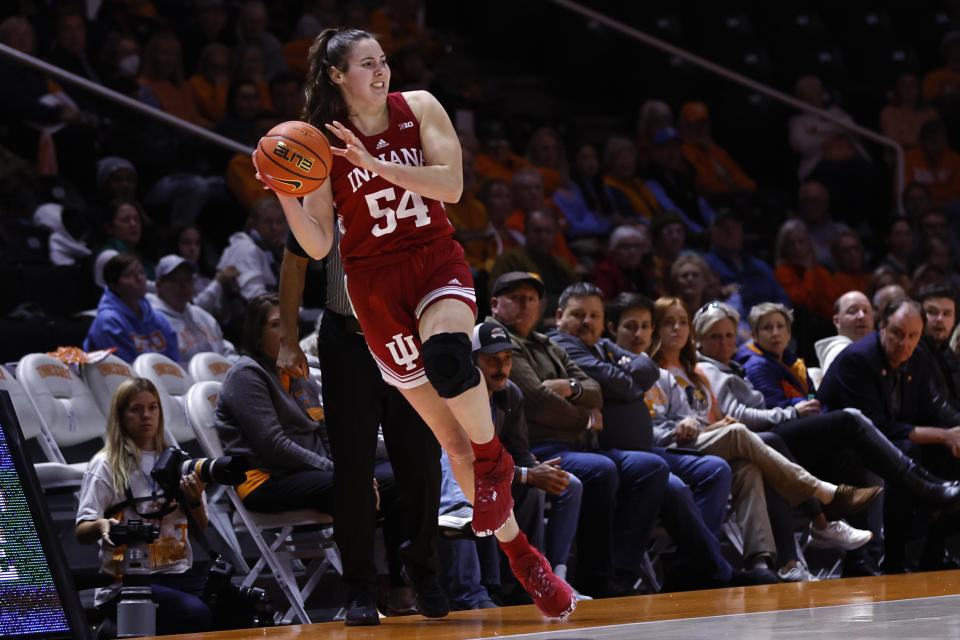 FILE - Indiana forward Mackenzie Holmes (54) saves the ball from going out of bounds during the second half of the tema's NCAA college basketball game against Tennessee, Nov. 14, 2022, in Knoxville, Tenn. Five players, including Grace Berger, are averaging at least 10 points. The group is led by 6-foot-3 forward Holmes (20.0), a two-time all-conference selection coming off an injury-plagued 2021-22. (AP Photo/Wade Payne, File)