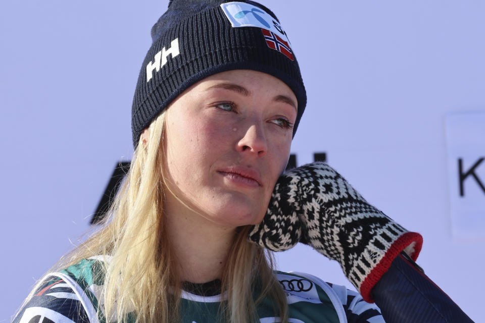 Norway's Kajsa Vickhoff Lie is overcome by emotion as she celebrates on the podium after winning an alpine ski, World Cup women's downhill race, in Kvitfjell, Norway, Saturday, March 4, 2023. (AP Photo/Marco Trovati)