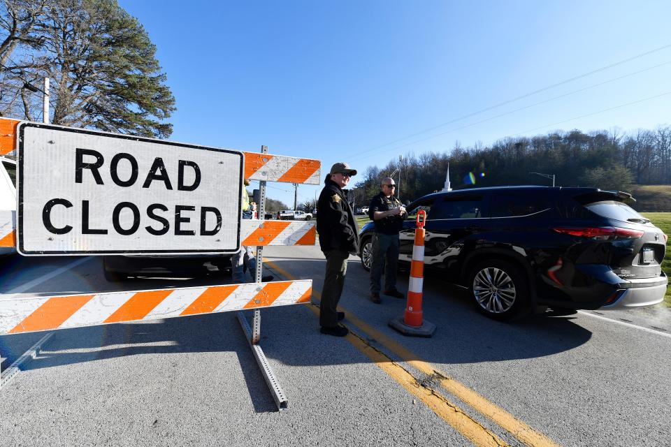 Rockcastle County Sheriff stop vehicles at a roadblock leading into downtown Livingston, Ky., Thursday, Nov. 23 2023 in Livingston Ky. A CSX train derailed outside of Livingston prompting an evacuation of the town.