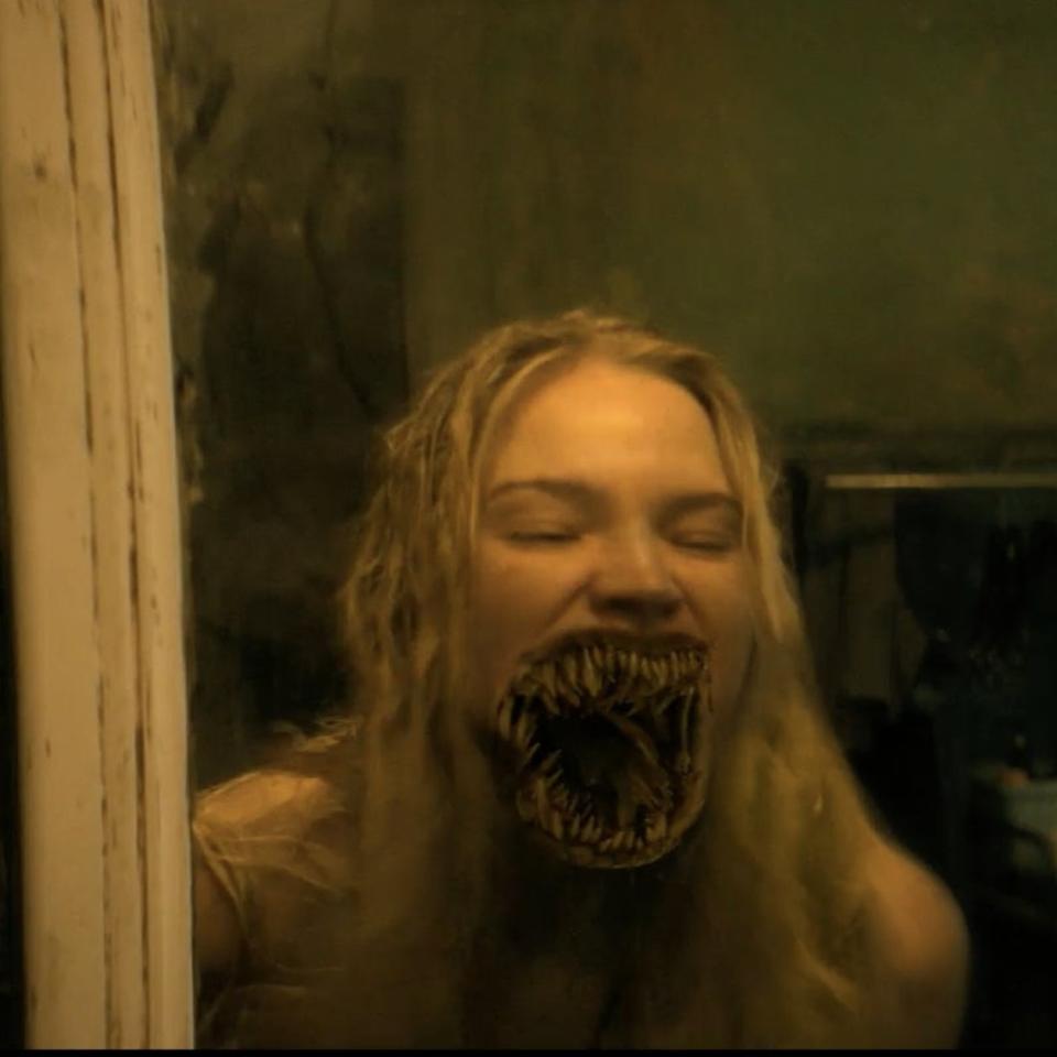 Sasha Luss in a horror scene with distorted monstrous reflection in mirror