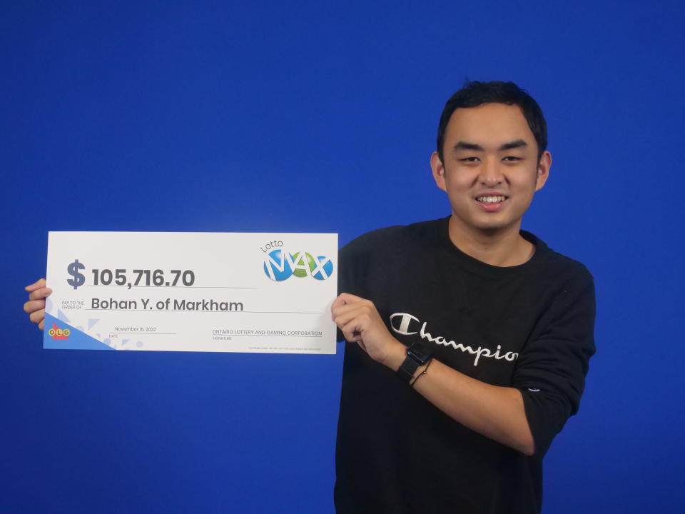 Bohan Ye seen holding a large Lotto Max check worth $105,716.70.