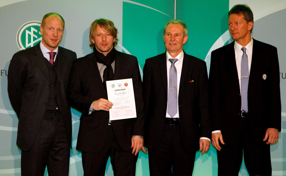 Sven Mislintat (2nd L) receives his DFB Football Trainer Certificate from Matthias Sammer (L), Rainer Milkoreit (2nd R) and Frank Wormuth (R) at the hotel Wasserturm on March 17, 2011 in Cologne, Germany.