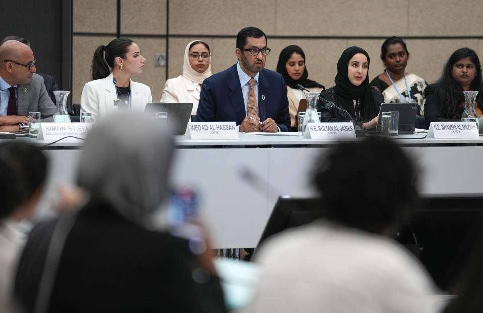 Sultan al-Jaber, center, who will preside over the next UN global climate summit in Dubai, talks to delegates at the United Nations Climate Change Conference in Bonn, Germany, Thursday, June 8, 2023. Al-Jaber said he wants the COP28 summit in Dubai to be "inclusive" and deliver a “game-changing outcome” for international efforts to tackle climate change. (AP Photo/Martin Meissner)