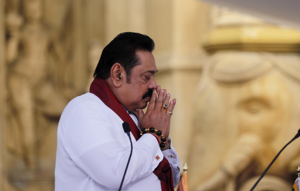 Sri Lanka’s former President Mahinda Rajapaksa, prays before being sworn in as the prime minister at Kelaniya Royal Buddhist temple in Colombo, Sri Lanka, Sunday, Aug. 9, 2020. (AP Photo/Eranga Jayawardena)