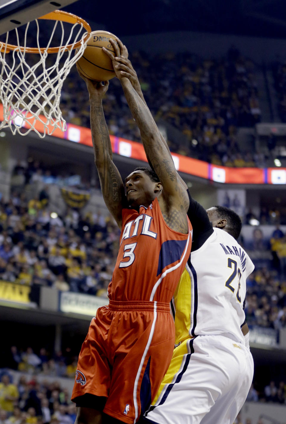 Atlanta Hawks' Louis Williams (3) goes up for a shot as Indiana Pacers' Ian Mahinmi, right, defends during the first half in Game 5 of an opening-round NBA basketball playoff series Monday, April 28, 2014, in Indianapolis. (AP Photo/Darron Cummings)