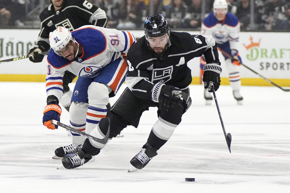 Los Angeles Kings defenseman Drew Doughty, right, takes the puck as Edmonton Oilers left wing Evander Kane reaches in during the first period in Game 4 of an NHL hockey Stanley Cup first-round playoff series Sunday, April 28, 2024, in Los Angeles. (AP Photo/Mark J. Terrill)