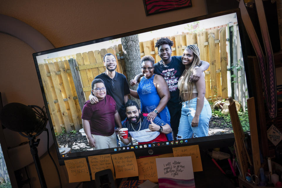 A photograph of Melanese Marr-Thomas, center, with her children is displayed as her computer desktop background in her home in District Heights, Md., on Wednesday, Sept. 21, 2022. (AP Photo/Wong Maye-E)