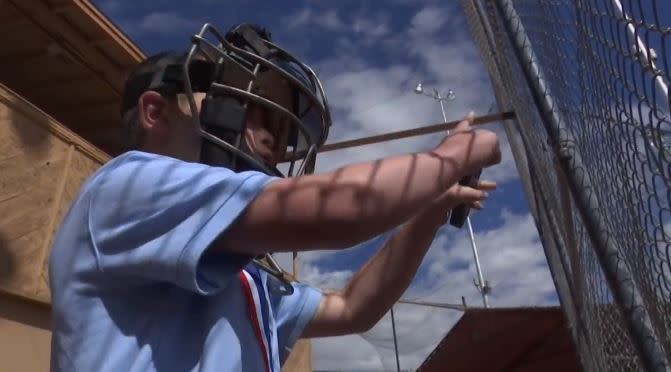 Trenton Garrison decided to stay involved in the game he loves by becoming an umpire at his older brother’s baseball games. (Screen shot)