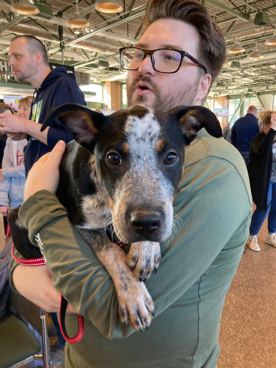 Drew Domalick, a volunteer with Happily Ever After, handed off a very special girl to anyone who looked like they needed to hold a pup. Ellie, the three-month-old blue heeler, will grow to around 150 pounds by adulthood, so she's getting all the cradling she can in now at Johnsonville Tailgate Village in Ashwaubenon, Wis.