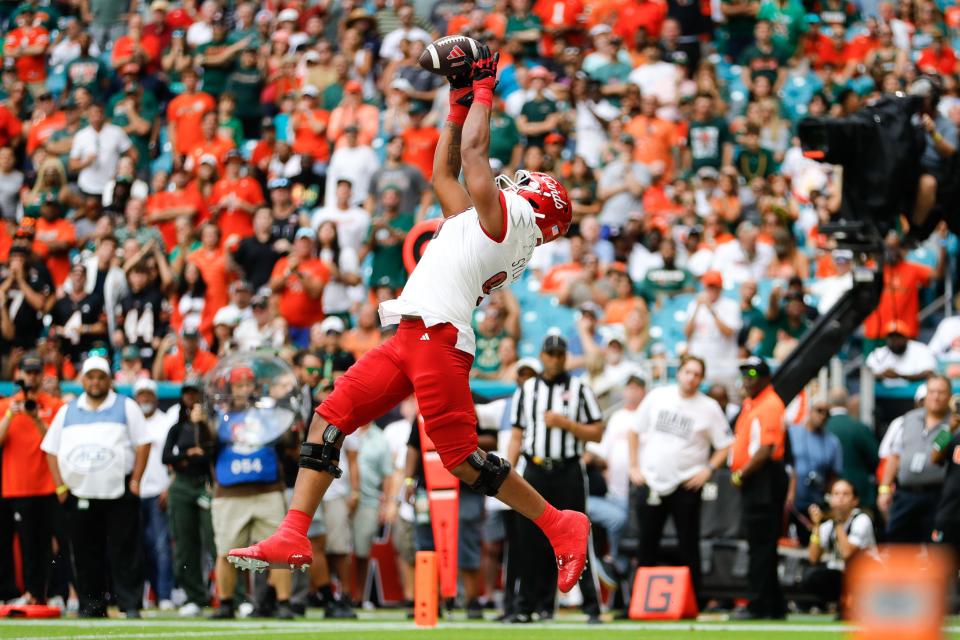 Louisville Cardinals offensive lineman Trevonte Sylvester (70) catches the ball for a touchdown against the Miami Hurricanes during the second quarter at Hard Rock Stadium.