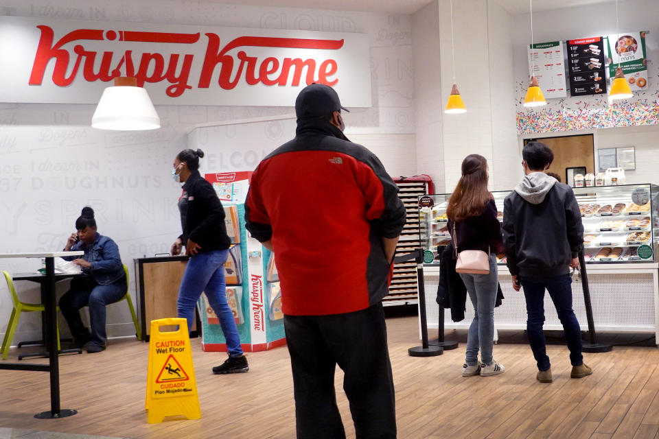 CHICAGO, ILLINOIS - MAY 05: Customers shop at a Krispy Kreme store on May 05, 2021 in Chicago, Illinois. The doughnut chain reported yesterday that it plans to take the company public again. The company was taken public in 2000 but struggled before being acquired by JAB Holding Company in 2016. (Photo by Scott Olson/Getty Images)