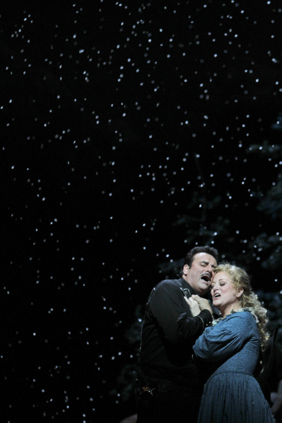 FILE - This Friday, Dec. 3, 2010, file photo shows Marcello Giordani, left, performing as Ramerrez alongside Deborah Voigt performing as Minnie during the final dress rehearsal of Giacomo Puccini's "La Fanciulla del West," at the Metropolitan Opera in New York. Tenor Marcello Giordani, renowned for a voice of beauty and heft that made him a star at the world's top opera houses, died Saturday, Oct. 5, 2019. He was 56. (AP Photo/Mary Altaffer, File)