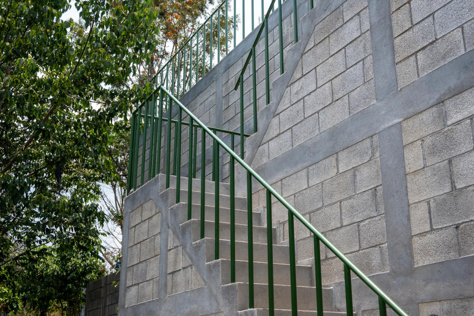 green bannister to concrete stairway