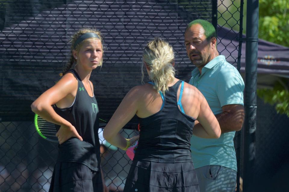 Fossil Ridge tennis coach Mike Scimeca, with hair dyed green, talks to his No. 1 doubles team during the Class 5A semifinals on Saturday, June 12, 2021.