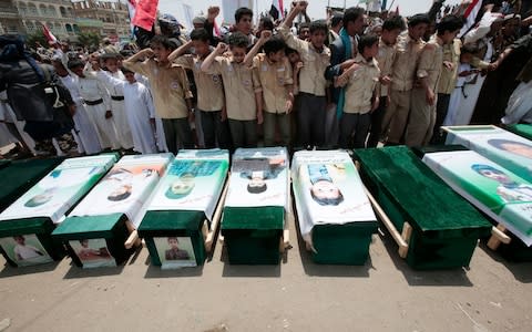 Yemeni people attend the funeral of victims of a Saudi-led airstrike, in Saada, Yemen. - Credit: AP